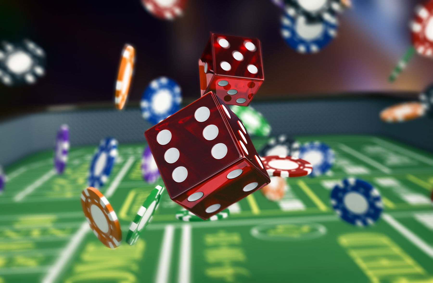 Dice and chips falling onto a craps table