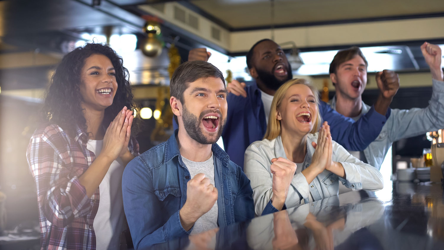 Sportsbar - Group of guests rooting on their team, while watching a sports event