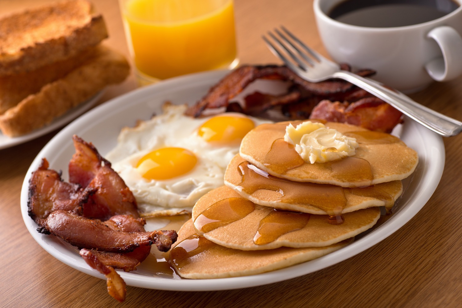 Food Court - Plate of pancakes, bacon and eggs