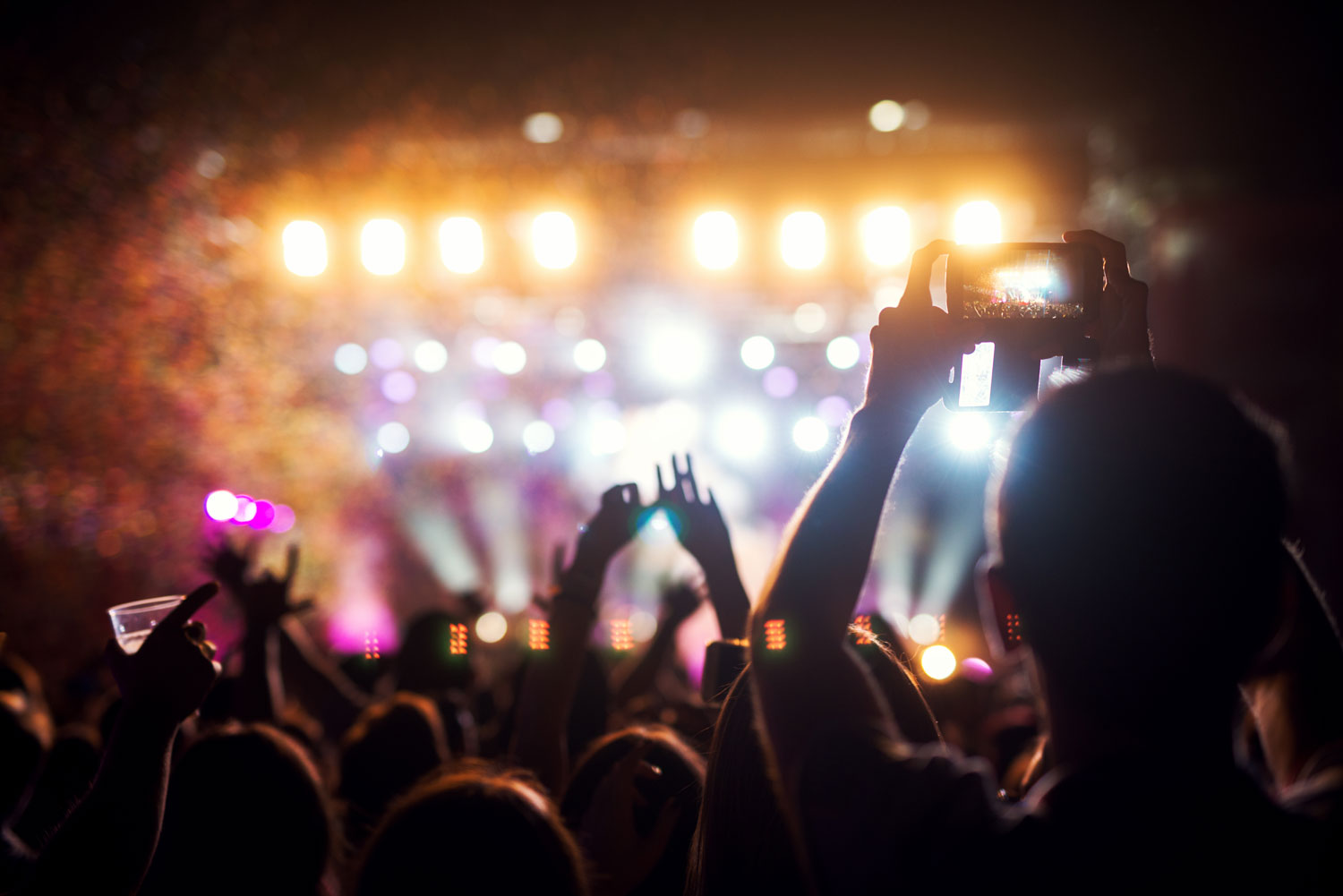 Showroom At Wheeling Island - Audience at concert holding up phones to take a photo or video of the entertainment