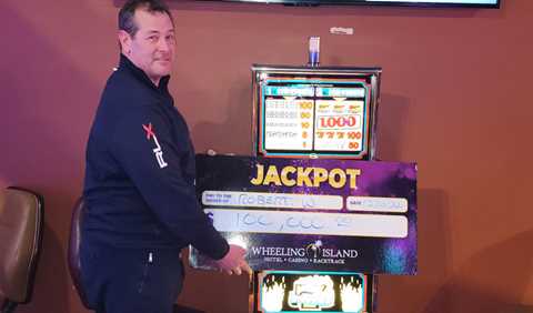 Winners - Jackpot winner with check for $100,000