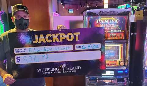 Winners - Jackpot winner with check for $9,916.92