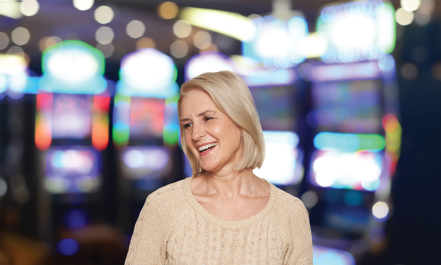 50 Plus Winsdays - Woman smiling and enjoying her time in the slots area